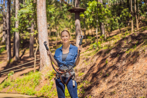 年轻迷人的女人在冒险绳公园的安全设备图片下载