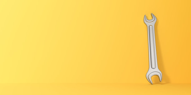 黄色背景上的扳手图片下载
