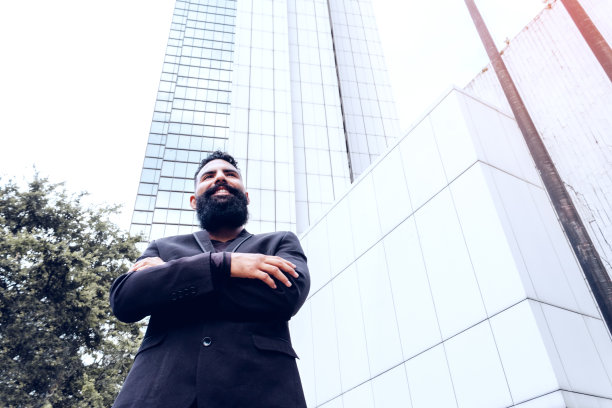 身着白人黑色西装，长胡子交叉双臂的商业高管图片下载