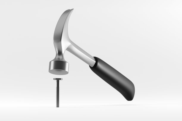 黑色塑料柄羊角锤敲击白色背景上的钉子。图片下载