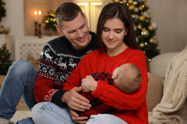 幸福的夫妇和可爱的婴儿在房间装饰圣诞节图片下载