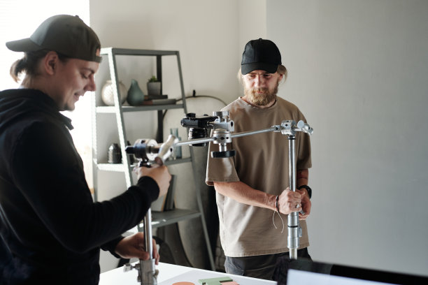 年轻助理帮助摄影师或摄像师调整斯坦尼康图片下载