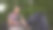 一个年轻人推着婴儿车坐在公园里看书。爸爸坐在公园里的长凳上摇晃婴儿车。图片下载
