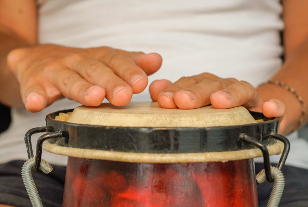 女人的手在敲非洲鼓。打击乐疗法工作坊。图片下载