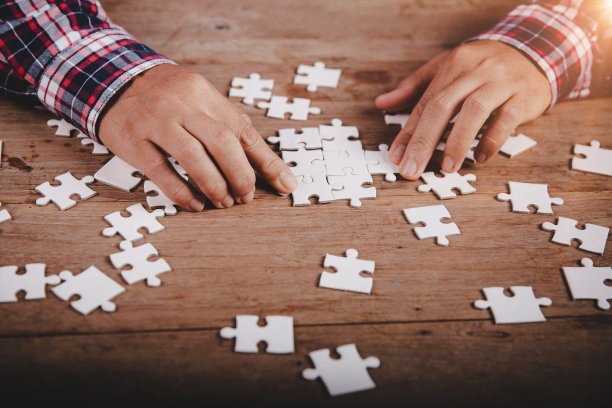 双手捧着木桌背景上的拼图片，成功商业，解决策略，团队合作理念图片下载