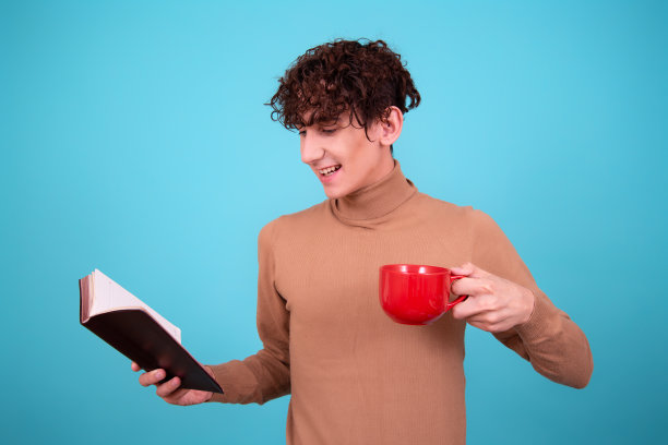 年轻迷人的学生拿着一本书。图片下载