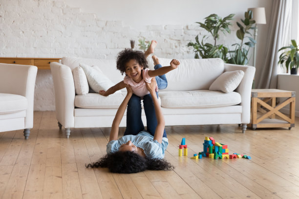 年轻的非洲母亲和可爱的小女儿在家里玩耍图片下载