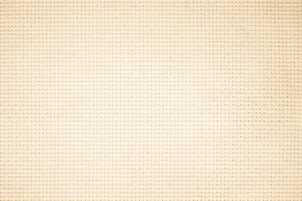 织物帆布编织质地背景图案在浅米色奶油棕色的颜色空白。天然纱布亚麻、地毯羊毛和棉布纺织为布袋材料，清洁空作装饰文字。图片下载