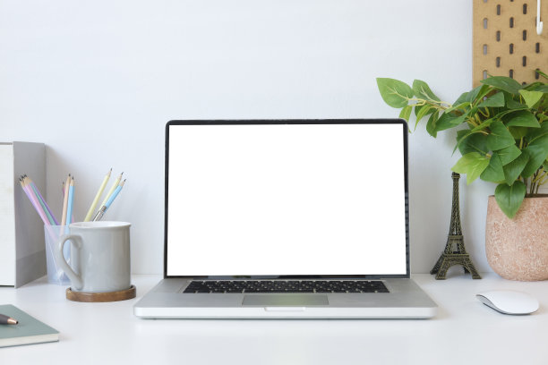 现代办公场所，笔记本电脑，相框，文具和花盆。空白屏幕为您的广告文字。图片下载