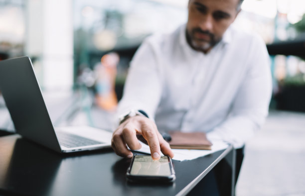 模糊的商人使用智能手机键盘在街头咖啡馆远程工作时发送信息信息和短信，选择性地关注连接4g的现代智能手机技术图片下载