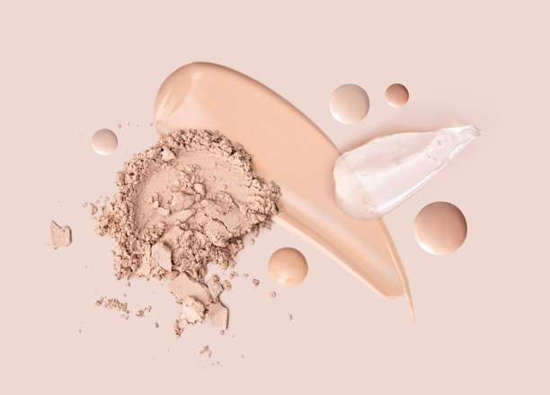 化妆涂抹粉底霜粉在米色背景图片下载
