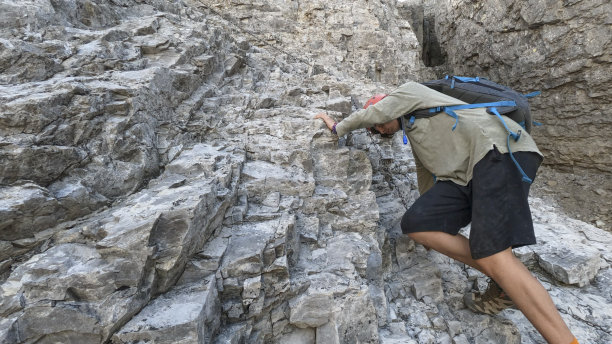 少年用链子爬上岩壁图片下载