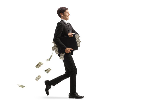 一个年轻的商人带着公文包走着，钱落在后面图片下载