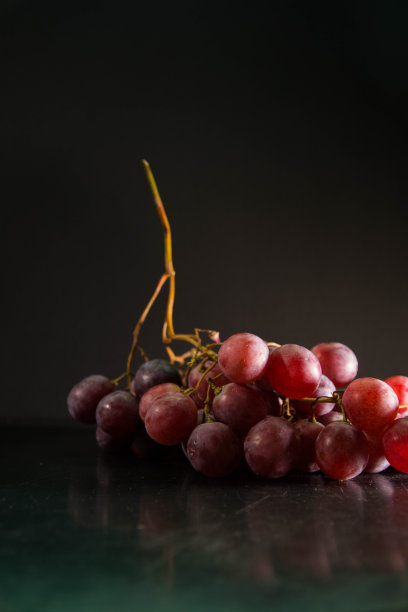 黑色背景上的一串葡萄。文本空间图片下载