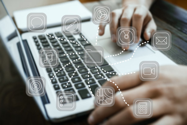 概念图。背景上不同的图标女性的手在笔记本电脑的水平框架后面图片下载