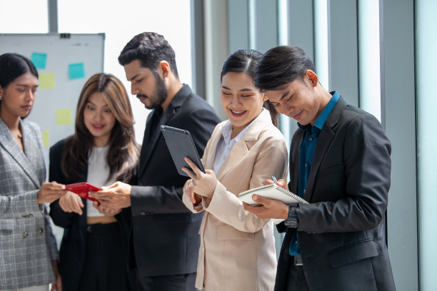 业务团队男女同事在工作中交谈，手中拿着数据报告，分享想法，快乐的同事在办公室一起工作。图片下载