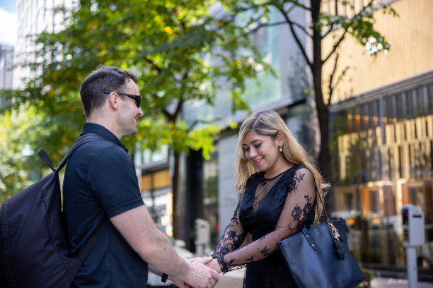 一对情侣在城市街道上牵着手图片下载