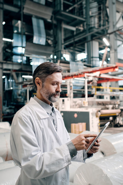 男子在工厂拿着平板电脑图片下载