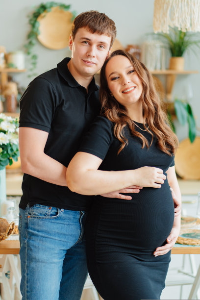 孕妇和穿黑色衣服的男人拥抱，一对夫妇图片下载