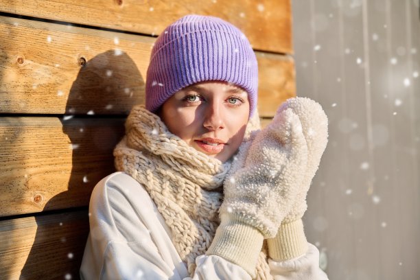 冬季肖像年轻女子看着相机与雪花在脸上图片下载