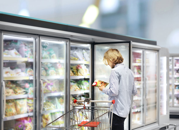 年轻人在超市购物，阅读产品信息图片下载