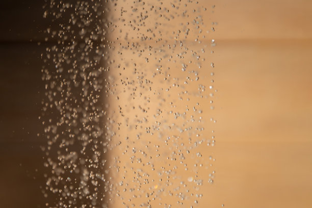 抽象背景水滴止水运动和滴落到地面从淋浴模糊橙棕色背景在室外光。图片下载