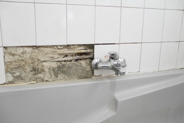 一间破旧的浴室，白色瓷砖破损，发霉图片下载