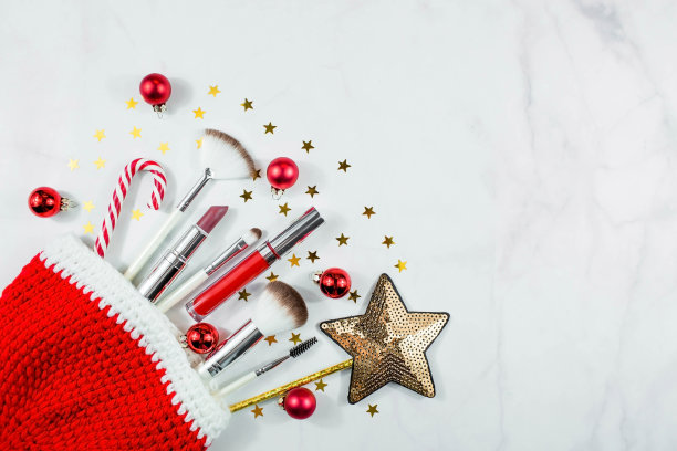 横幅。平面布局的组成与装饰化妆品产品和圣诞老人帽子在光的背景。冬季保健。美和时尚的概念。图片下载