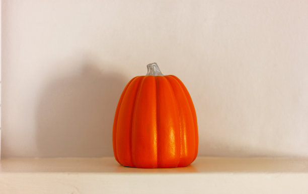白色架子上的橙色南瓜。万圣节和感恩节的家居装饰图片下载