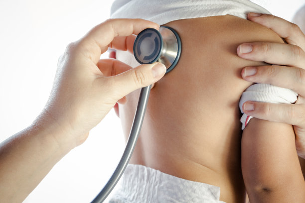用听诊器从后面听婴儿说话的儿科医生图片下载
