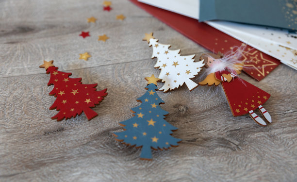 三棵木制圣诞树和一个圣诞天使是为圣诞节和新年手工制作的木制装饰品。图片下载