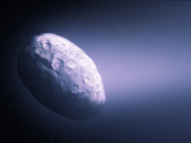 夜空中有明亮尾巴的发光彗星表面。图片下载