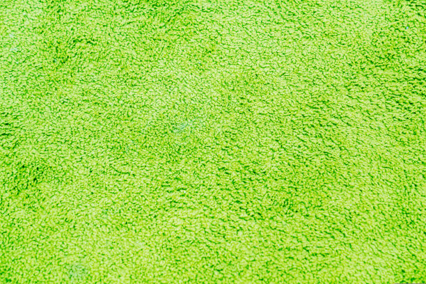 绿色地毯的质感。柔软的桩。家用和娱乐区用纺织品。地毯。图片下载