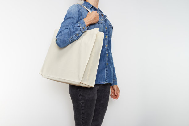 穿着牛仔衬衫、携带帆布环保手提袋的年轻女性（未识别）图片下载