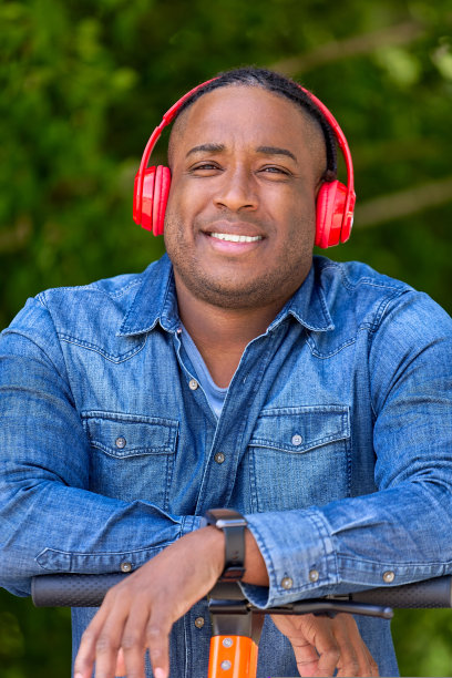 年轻的非洲企业家在拥有现代科技的绿色公园里摆姿势图片下载