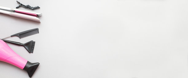 各种美发工具，如吹风机，梳子在灰色的背景。美容院的概念图片下载