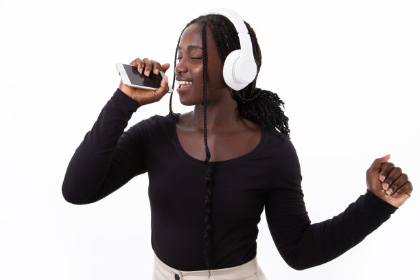 画像快乐的年轻女子在耳机录音的声音图片下载