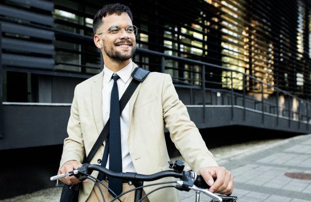 肖像的商人与自行车站在办公楼前图片下载
