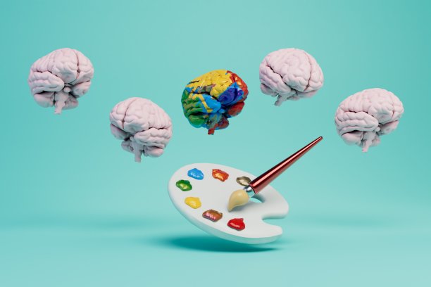大脑被涂上不同的颜色，在蓝绿色的背景上有一个调色板，上面有颜料和刷子。三维渲染图片下载