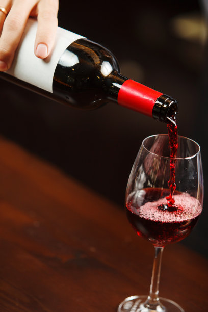服务员将红酒倒入酒杯。侍酒师倒酒图片下载