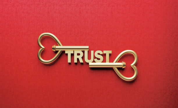用金色钥匙写在红色背景上的信任字图片下载