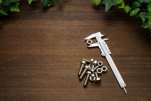 木制桌子上的金属游标卡尺图片下载