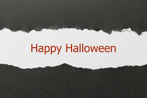 万圣节快乐写在撕破的纸下。图片下载