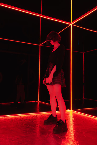 朋克的概念。一个梳着黑色短发、戴着黑色眼镜的赛博朋克女孩站在镜头前。游戏,虚拟现实图片下载