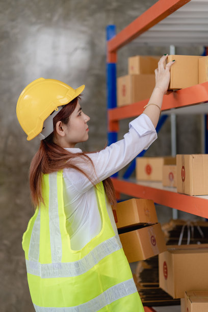 亚洲女性在线卖家在发送给客户之前会检查库存。一位电商老板在仓库里工作。图片下载