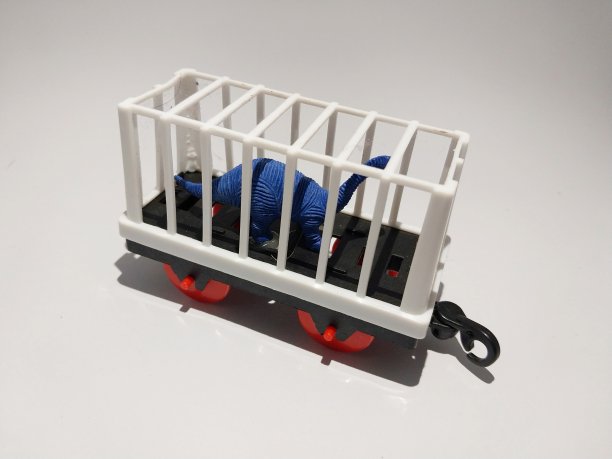 一张玩具火车车厢的照片。带着恐龙图片下载