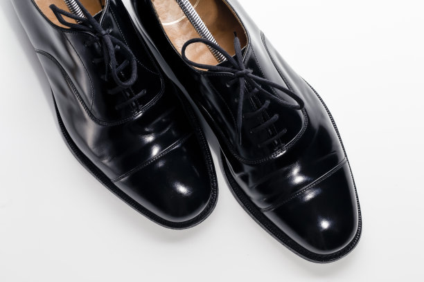 对角上视图对正式的男性时尚黑色抛光牛津皮革花边鞋放在一起超过白色。图片下载