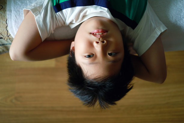 男孩躺在家里的沙发上，俯视图图片图片下载