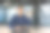 网络摄像头视图，成功的技术支持和客户服务人员的肖像，男人微笑着，看着镜头挥手问候你好，亚洲人在现代办公楼内工作图片下载