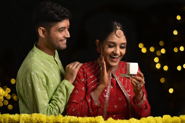 年轻夫妇庆祝排灯节，丈夫给妻子惊喜礼物库存照片图片下载